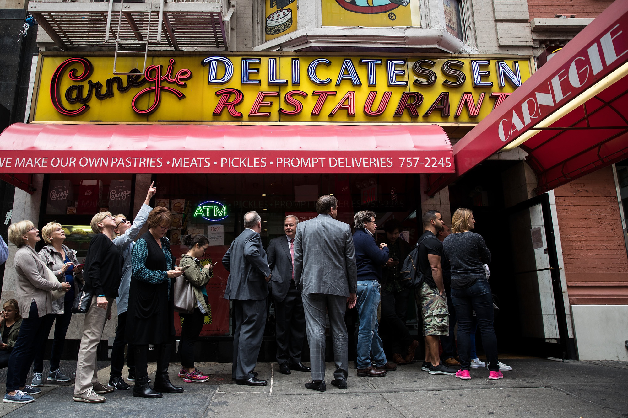 Customers wait in line outside for a table at the Carnegie Deli. (Photo: Drew Angerer/Getty Images) Customers wait in line outside for a table at the Carnegie Deli. (Photo: Drew Angerer/Getty Images)